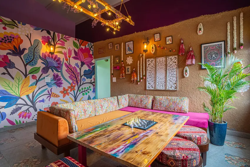 Quiet indoor lounge with comfortable seating and alpine mountain decor at Adrushya Estates