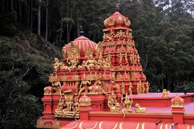 Golu Devta Temple structure with detailed carvings surrounded by trees