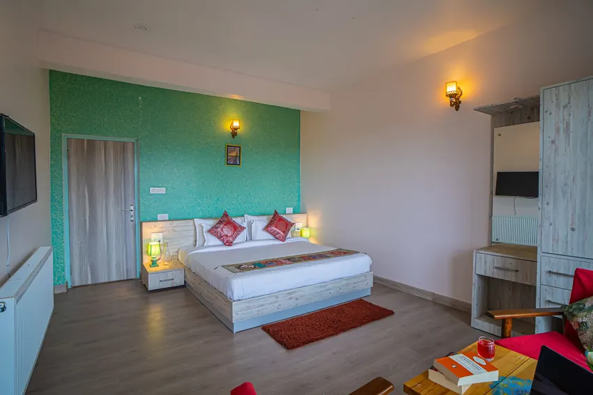 Wooden ceiling bedroom with double bed and forest windows at Adrushya Estates